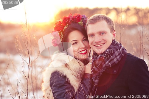 Image of Happy young couple smiling and hugging