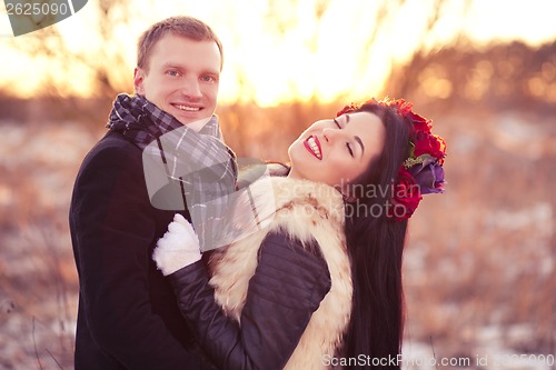 Image of Happy young couple smiling and hugging