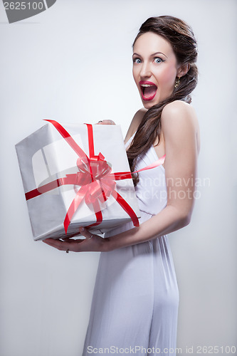 Image of Young smiling woman holding gift
