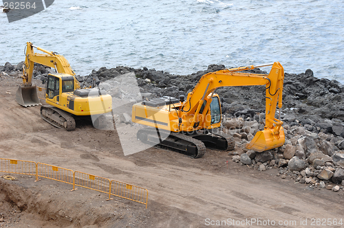 Image of Two orange excavators