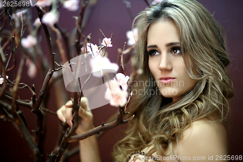 Image of Pretty Young Lady With Cherry Blossoms