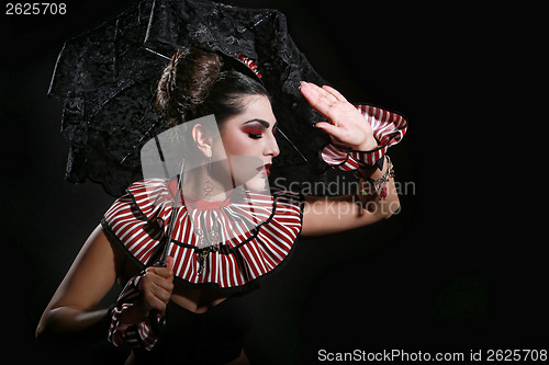 Image of Woman Wearing Striped Fashion With Dramatic Lighting 