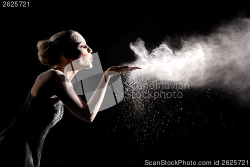 Image of Woman With Stop Motion of Explosive Powder Captured by Flash