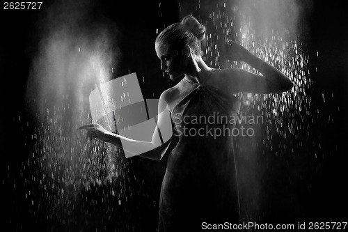 Image of Woman With Stop Motion of Explosive Powder Captured by Flash