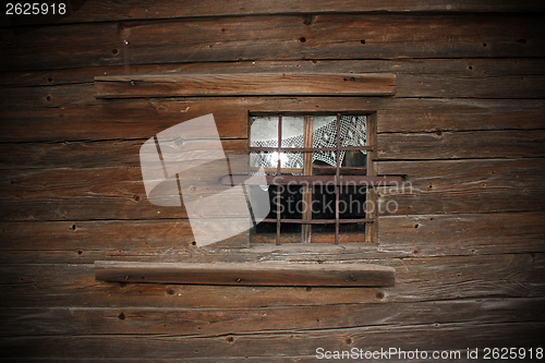 Image of window on old wooden church wall