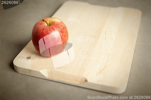 Image of apple on wooden cutting board