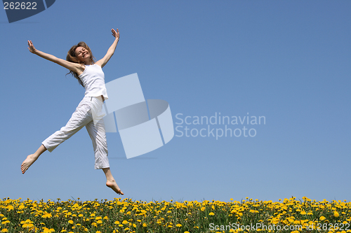 Image of Pretty girl dancing in flowering meadow