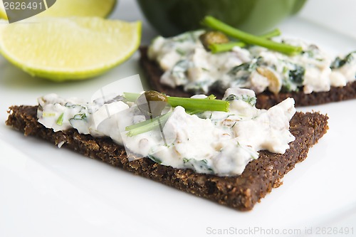 Image of sandwiches with dark bread, herrings, mushrooms, pepper