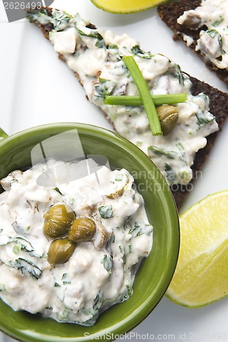 Image of sandwiches with dark bread, herrings, mushrooms, pepper