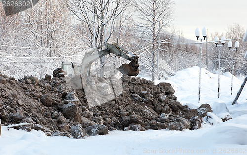 Image of Excavator digging frozen ground 