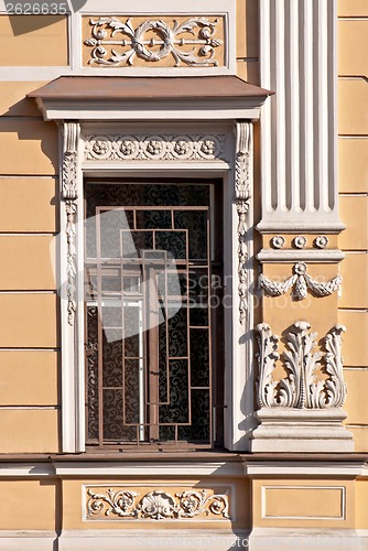 Image of A window with a bas-relief and grating.