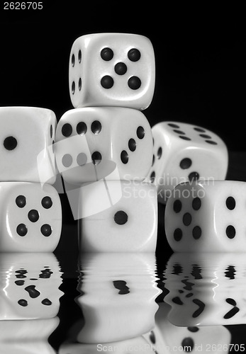 Image of sinking pile of white dice