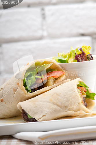 Image of kafta shawarma chicken pita wrap roll sandwich