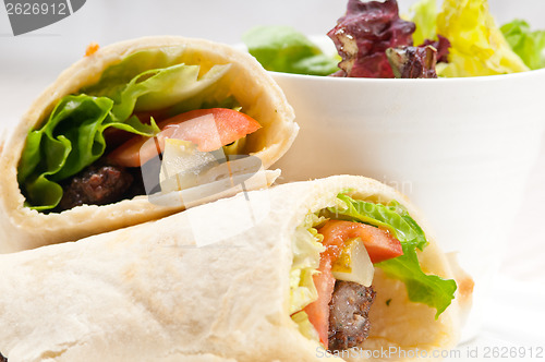 Image of kafta shawarma chicken pita wrap roll sandwich