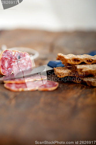 Image of italian salame pressato pressed slicing