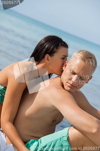 Image of Happy young couple sunbathing