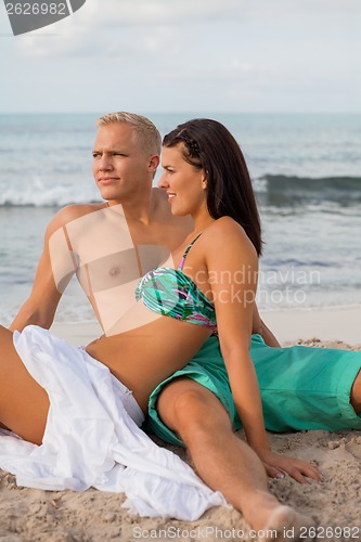 Image of Happy young couple sunbathing