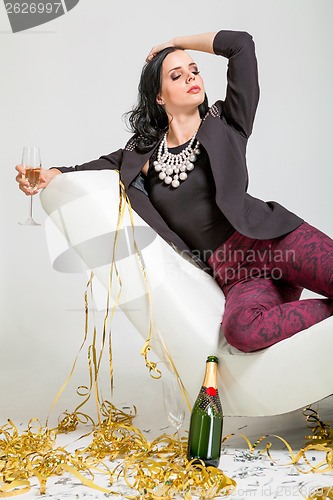 Image of Seductive brunette holding a glass of champagne