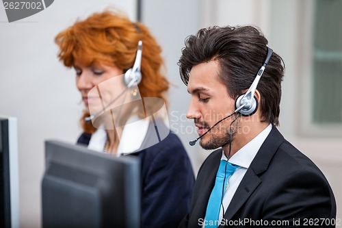 Image of friendly callcenter agent operator with headset telephone 