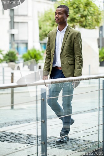 Image of young successful african business man outdoor in summer