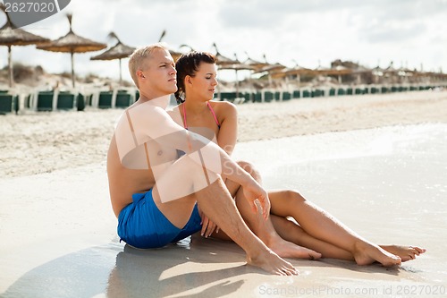 Image of Happy young couple sunbathing