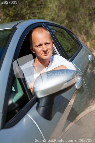 Image of Excited driver holding the keys of his new car