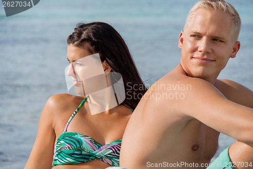 Image of Happy young couple sunbathing