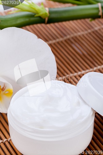 Image of cosmetic face cream on wooden background 