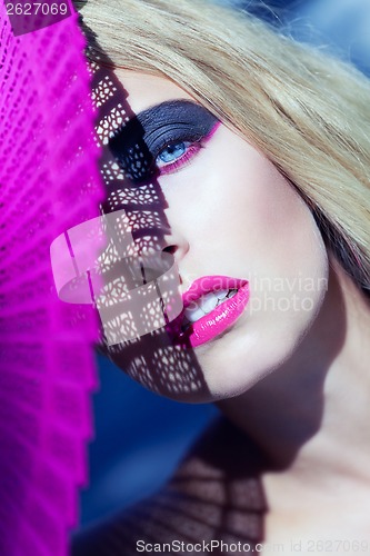 Image of young beautiful woman with smokey eyes and pink lips