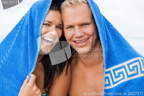 Image of Cheerful couple with a towel covering their heads