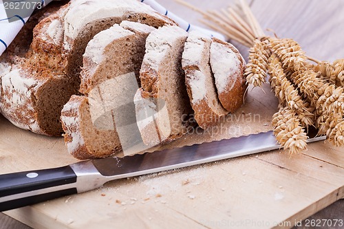 Image of homemade fresh baked bread and knife 