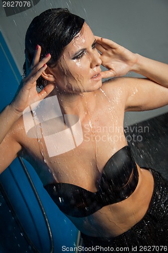 Image of Woman in black lingerie dripping water