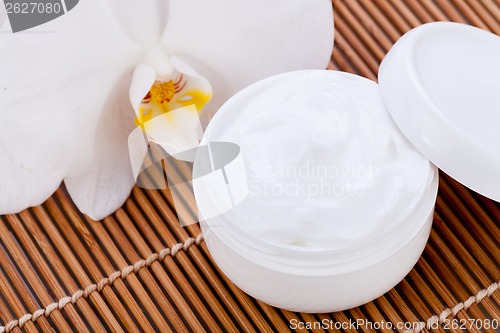 Image of cosmetic face cream on wooden background 