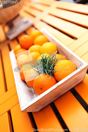 Image of fresh orange fruits decorative on table in summer