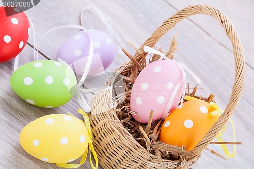 Image of colorful easter egg decoration on wooden background