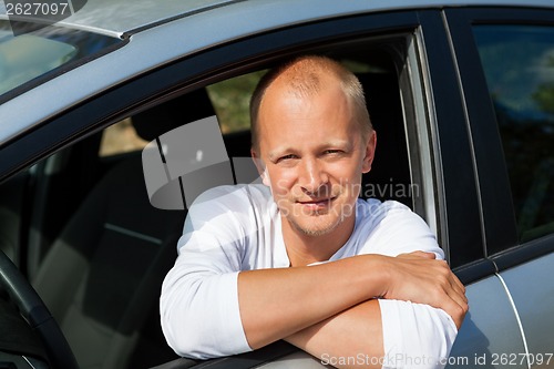 Image of Excited driver holding the keys of his new car