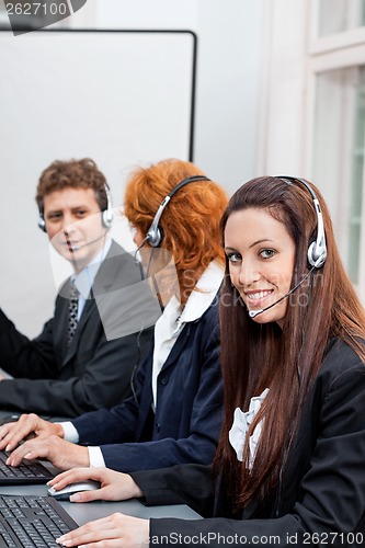 Image of friendly callcenter agent operator with headset telephone 