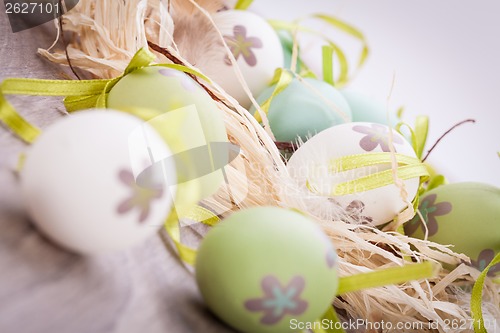 Image of Colourful green Easter eggs in straw