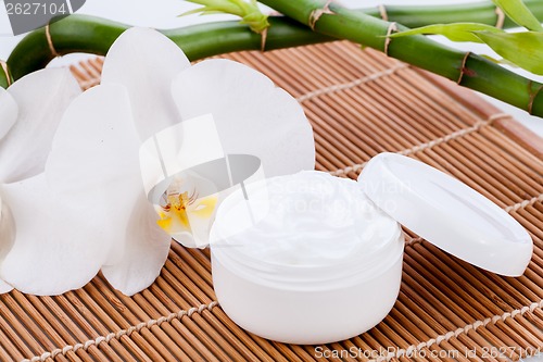 Image of cosmetic face cream on wooden background 