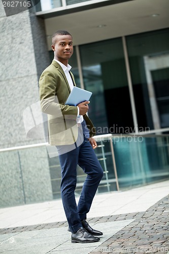 Image of young successful african business man outdoor in summer