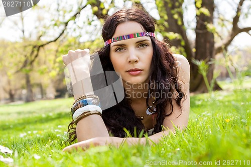 Image of Pretty young woman in a headband daydreaming