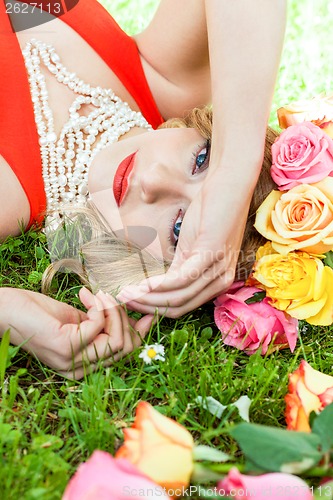 Image of beautiful woman portrait outdoor with colorful flowers