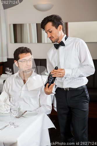 Image of young smiling couple at the restaurant 