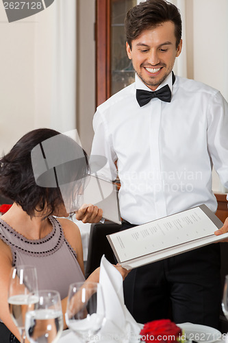 Image of young smiling couple at the restaurant 