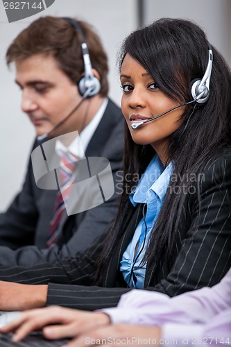 Image of friendly callcenter agent operator with headset telephone 