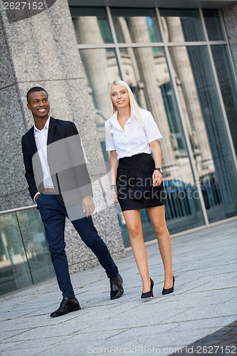 Image of young successful business man and woman outdoor