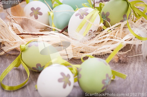 Image of Colourful green Easter eggs in straw