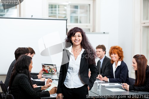 Image of professional successful business woman in office smiling