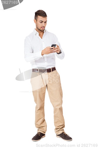 Image of Handsome man reading a message on his mobile