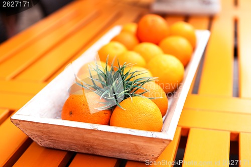 Image of fresh orange fruits decorative on table in summer